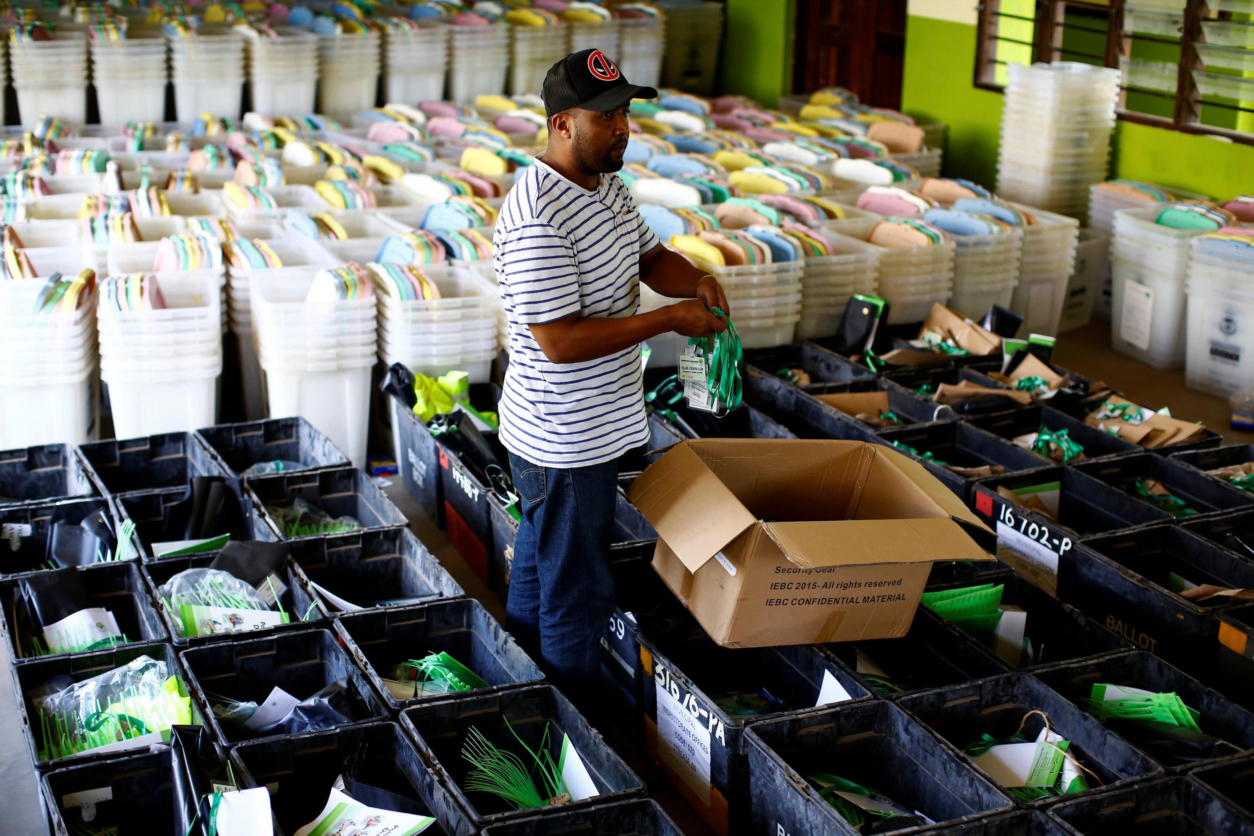 An election clerk in Mombasa organises polling material a day ahead of the presidential election