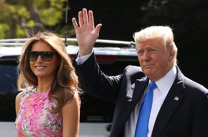 US President Donald Trump and First Lady Melania walk the South Lawn of the White House to board the Marine One helicopter July 25, 2017 in Washington, DC.