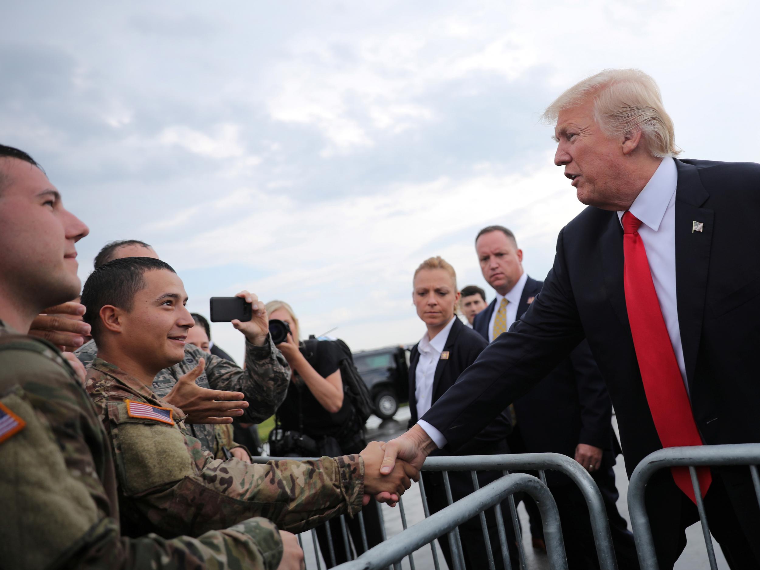 US President Donald Trump greets members of the military as he arrives at Raleigh County Memorial Airport in Beaver, West Virginia, on 24 July 2017