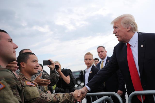 US President Donald Trump greets members of the military as he arrives at Raleigh County Memorial Airport in Beaver, West Virginia, on 24 July 2017