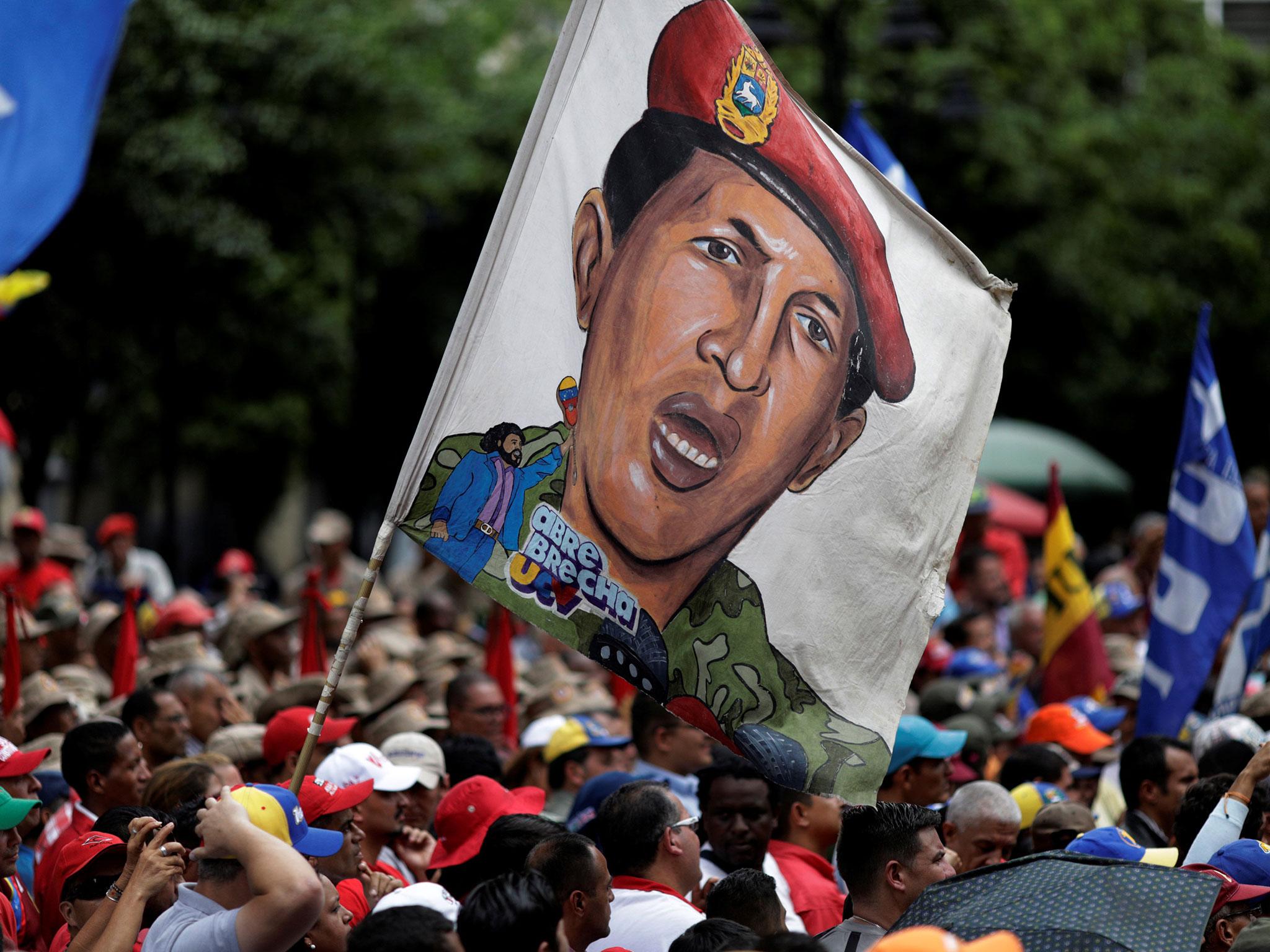 Pro-government supporters with an image of late President Hugo Chavez at a march in Caracas