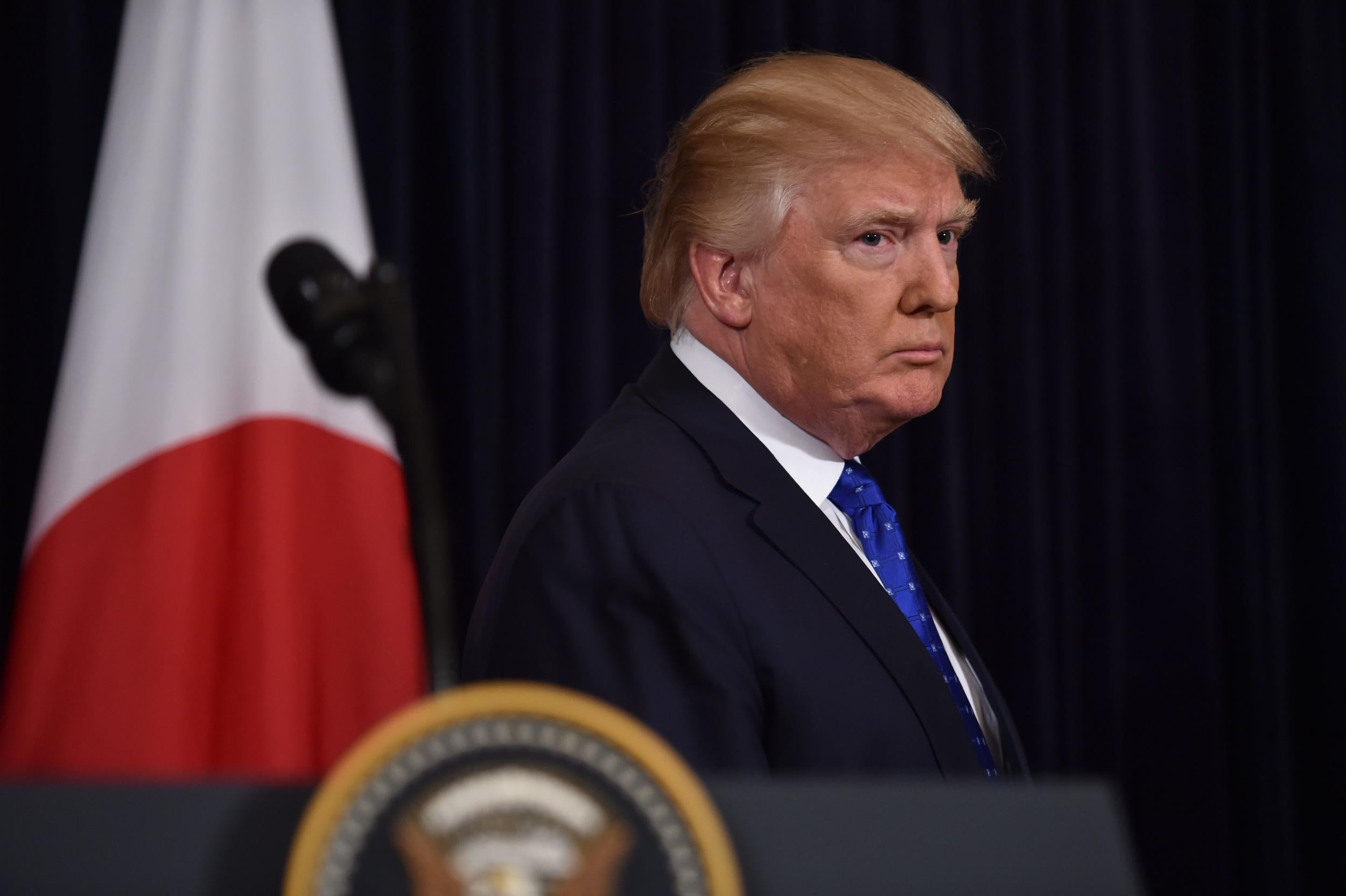 US President Donald Trump listens to Japanese Prime Minister Shinzo Abe speak after North Korea fired the first ballistic missile of Mr Trump's presidency