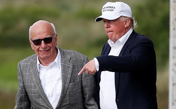 Trump speaks to Rupert Murdoch outside Trump International Golf Links in Aberdeen, Scotland (Reuters)