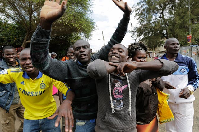 Supporters of Raila Odinga, leader of The National Super Alliance (NASA) coalition, shout slogans on a street after voting at a polling station in Huruma, Nairobi