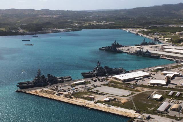 Aerial view from above US Naval Base Guam (NBG) showing Apra Harbor with several navy vessels in port, in Guam