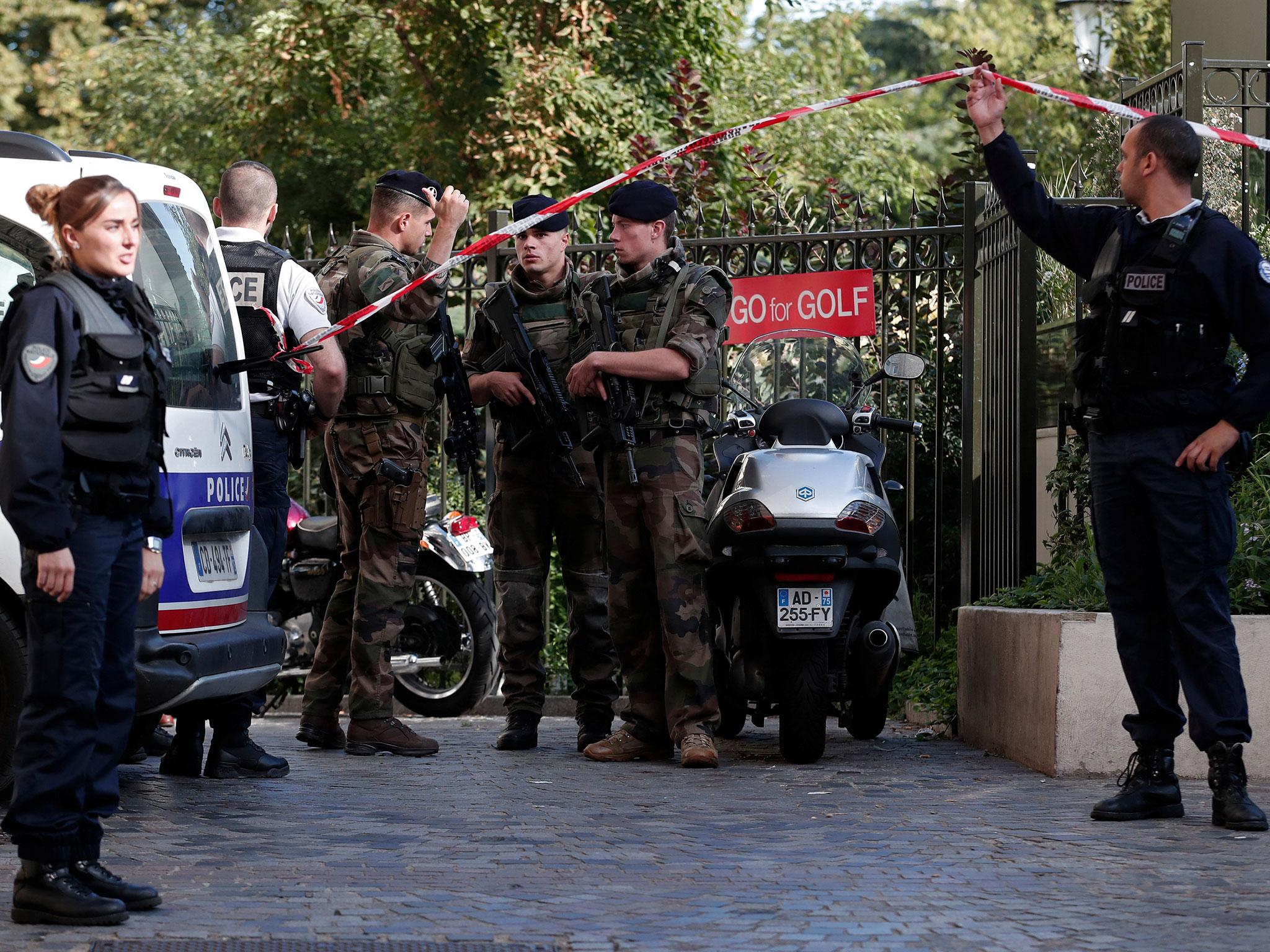 Police and soldiers secure the scene where French soliders were hit and injured by a vehicle in the western Paris suburb of Levallois-Perret