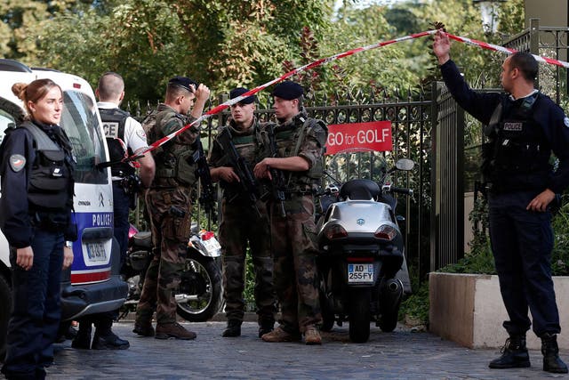 Police and soldiers secure the scene where French soliders were hit and injured by a vehicle in the western Paris suburb of Levallois-Perret