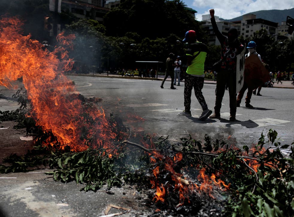 Demonstrators block a street at a rally against Venezuela's President Nicolas Maduro's government in Caracas