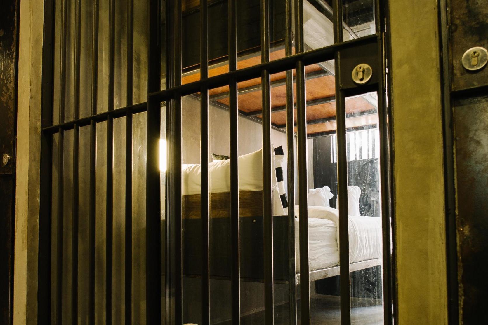 Rooms feature bunk beds, iron bars and metal doors