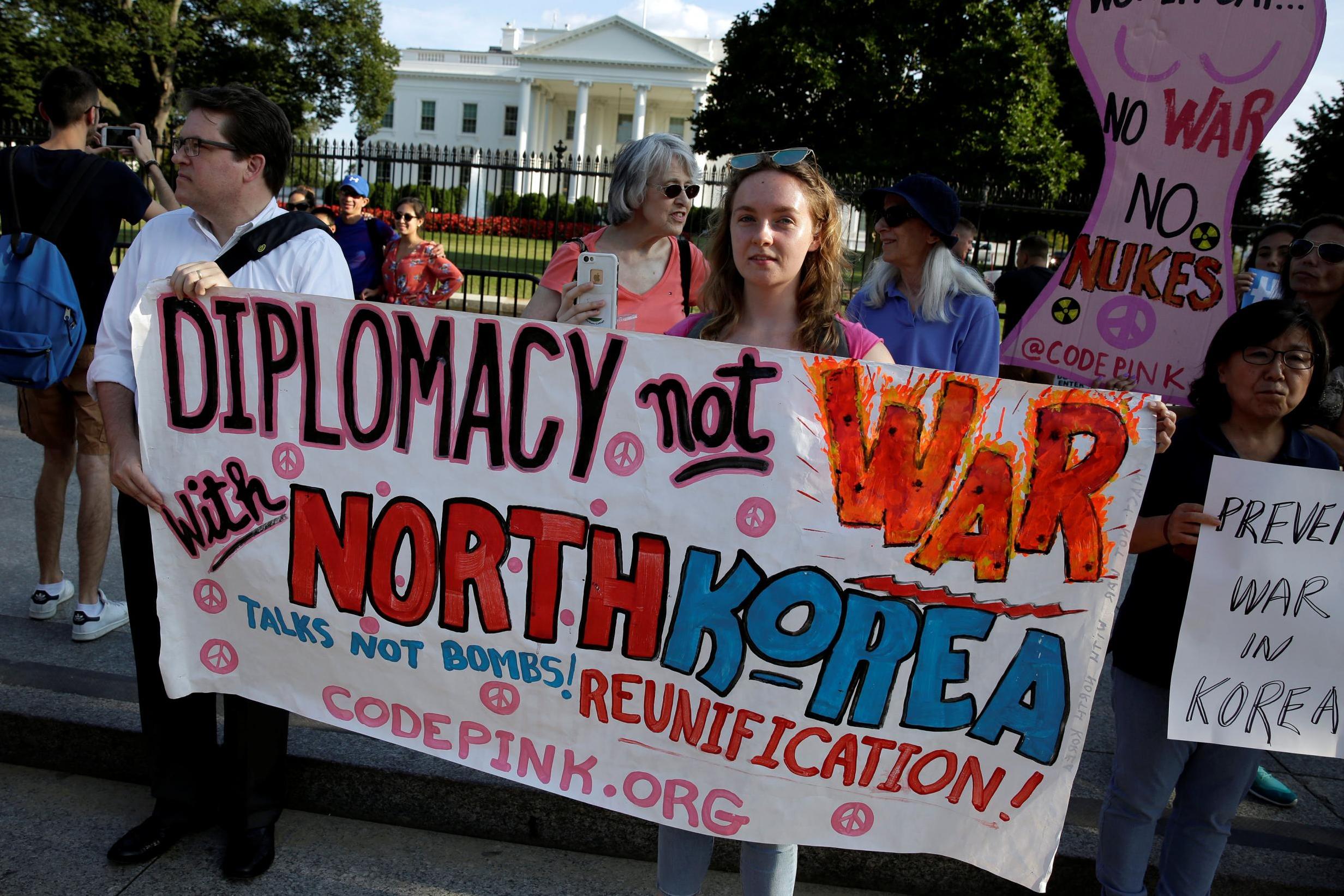 Protesters call for peaceful negotiations with North Korea at a demonstration outside the White House on Wednesday