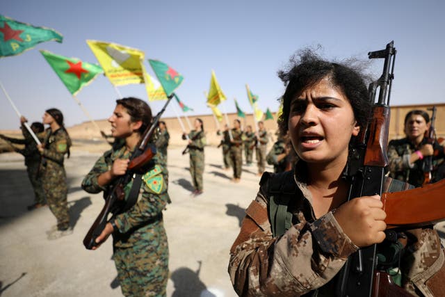 Syrian Democratic Forces female fighters hold their weapons during a graduation ceremony in the city of Hasaka, northeastern Syria on 9 August 2017