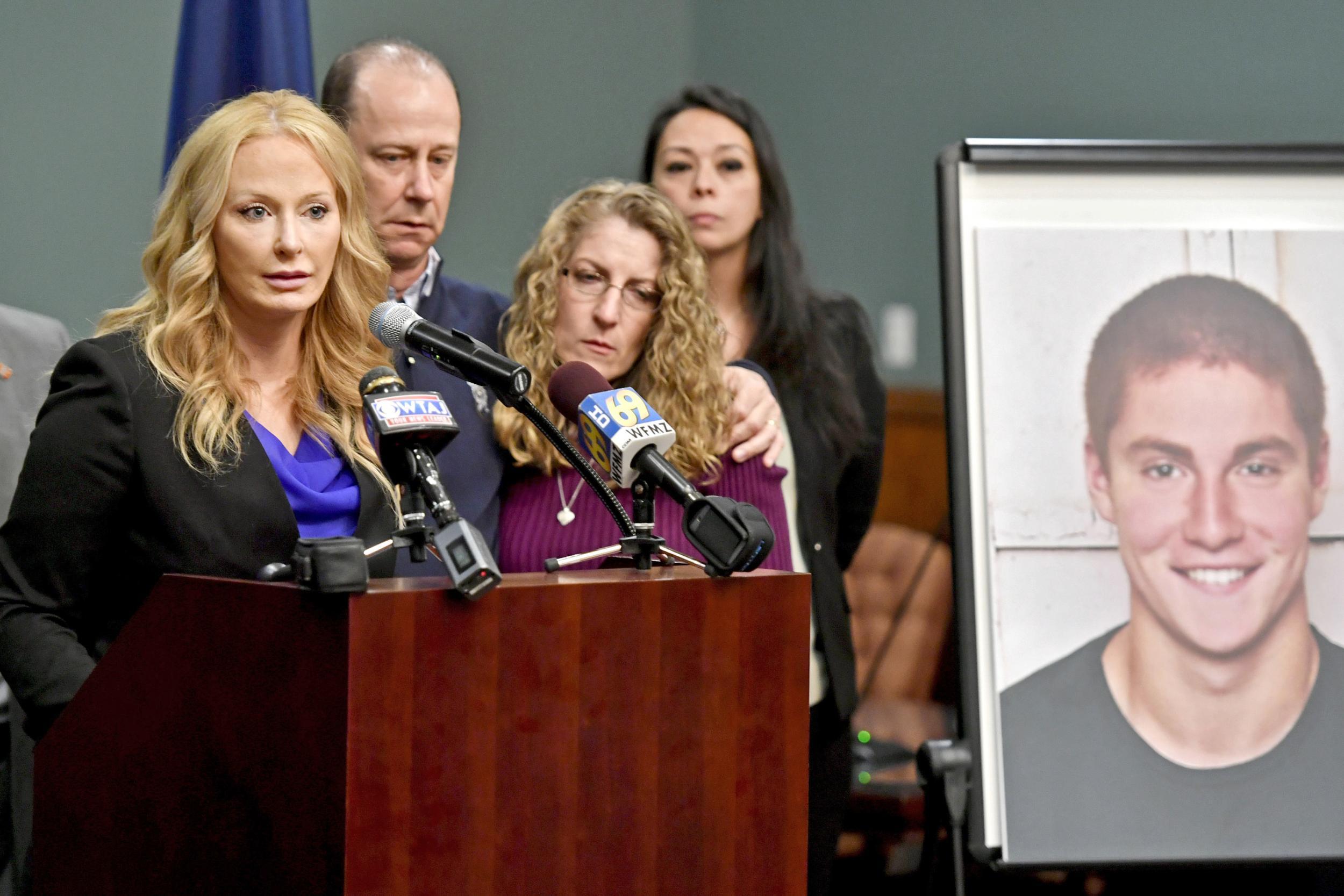 Centre County district attorney Stacy Parks Miller announces the findings of an investigation into Timothy’ death, flanked by his parents Evelyn and Jim (Centre Daily Times/AP)