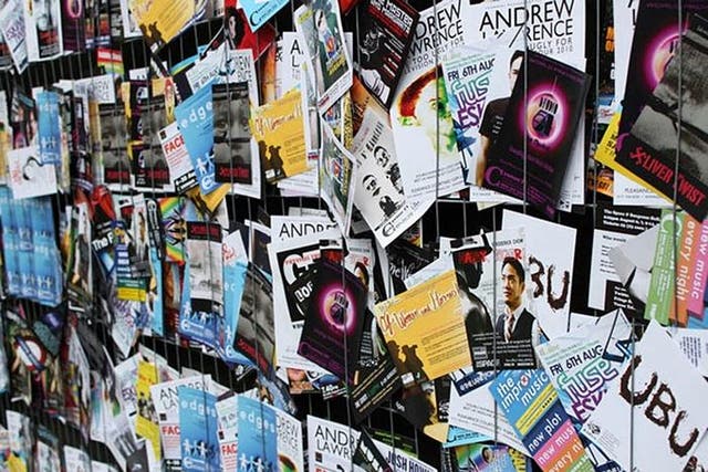 Fliers advertising Edinburgh Fringe Festival shows litter the streets of the Scottish capital