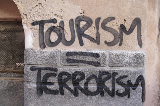Good riddance? A slogan spray-painted on a wall in Palma de Mallorca