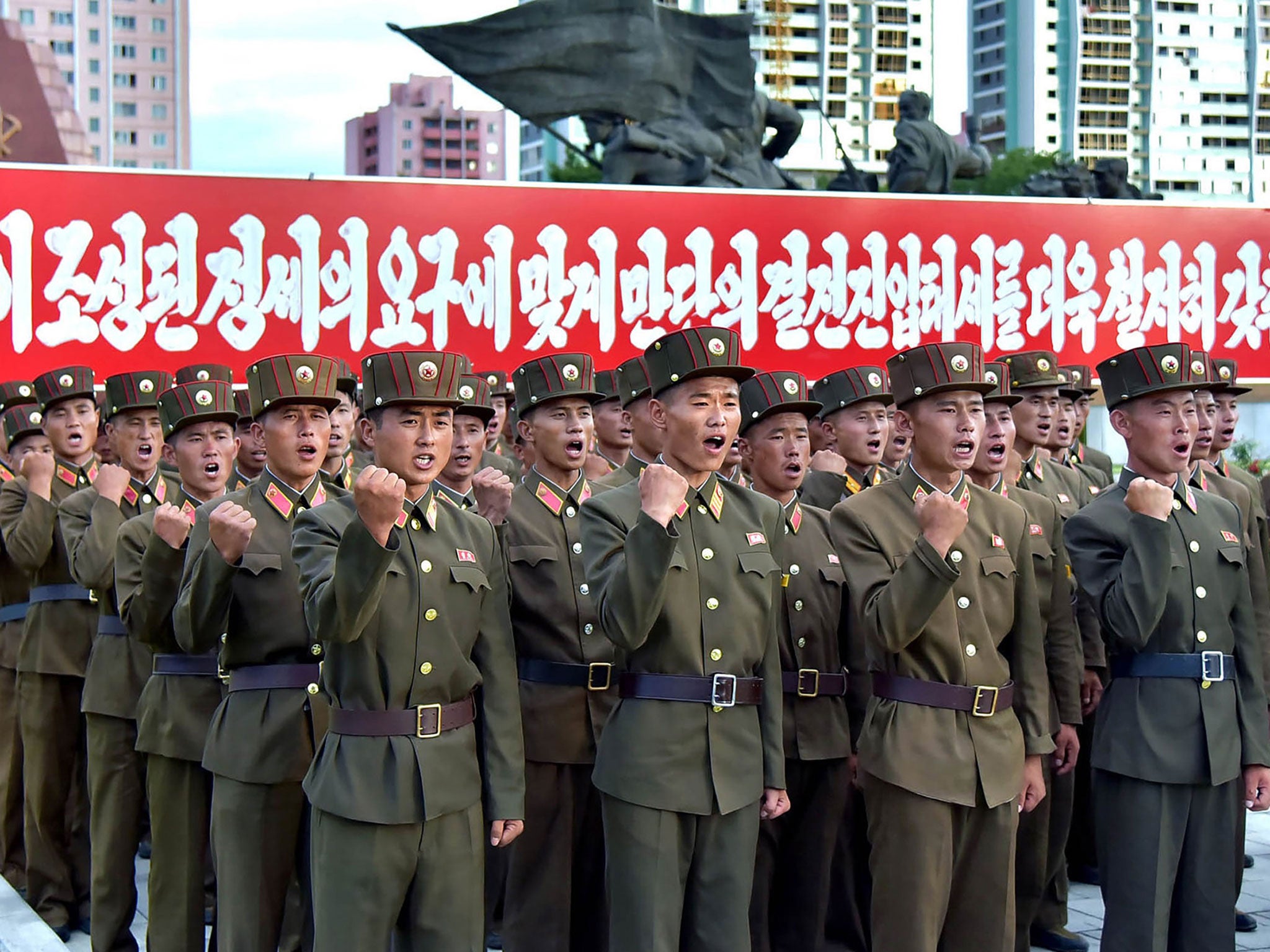 Picture released by KCNA shows North Korean service personnel at a rally in Pyongyang