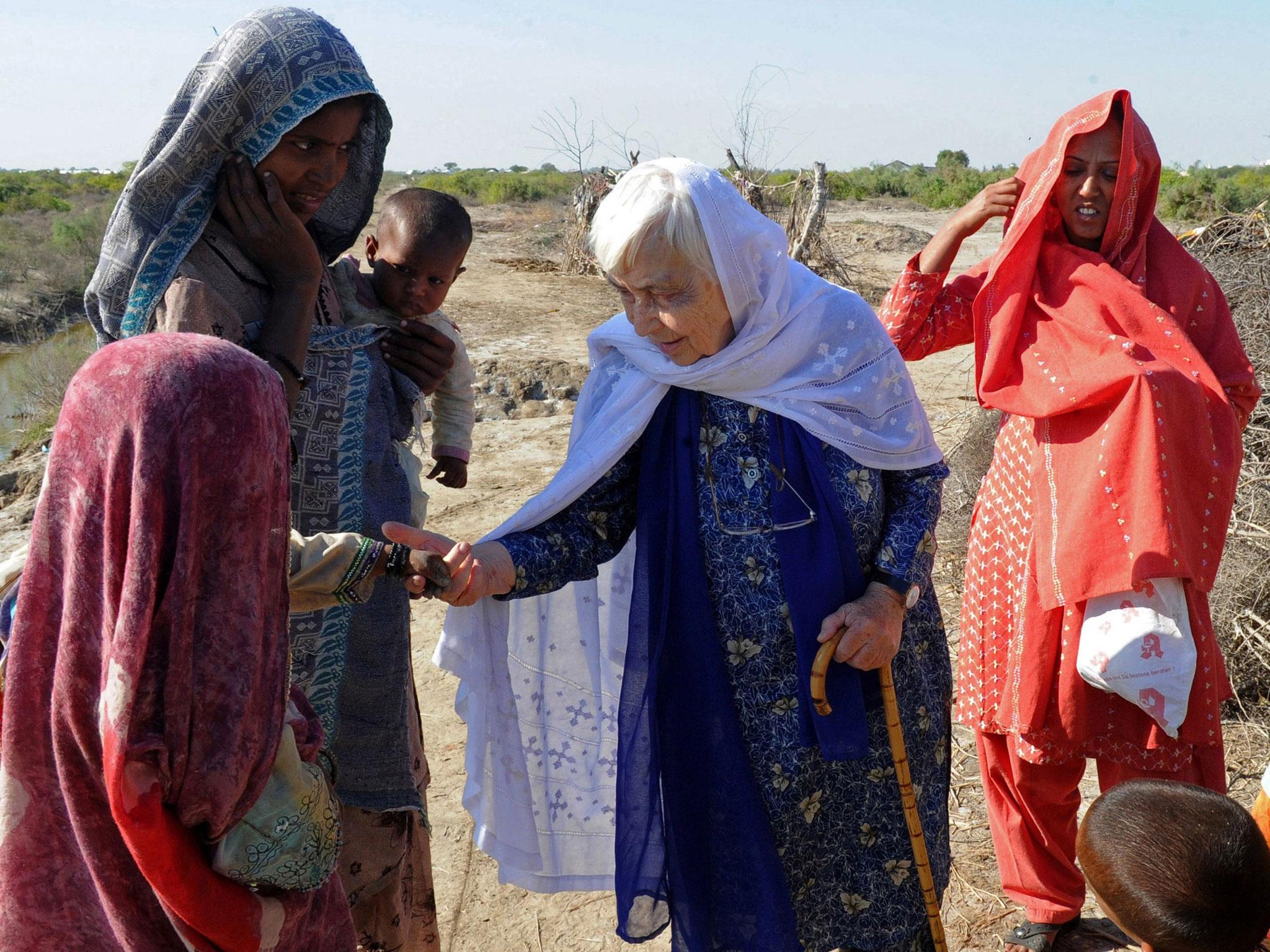 Ruth Pfau (C), head of a Pakistani charity fighting leprosy and blindness, meets people in flood-affected southern Pakistan in December 2010. She has died aged 87