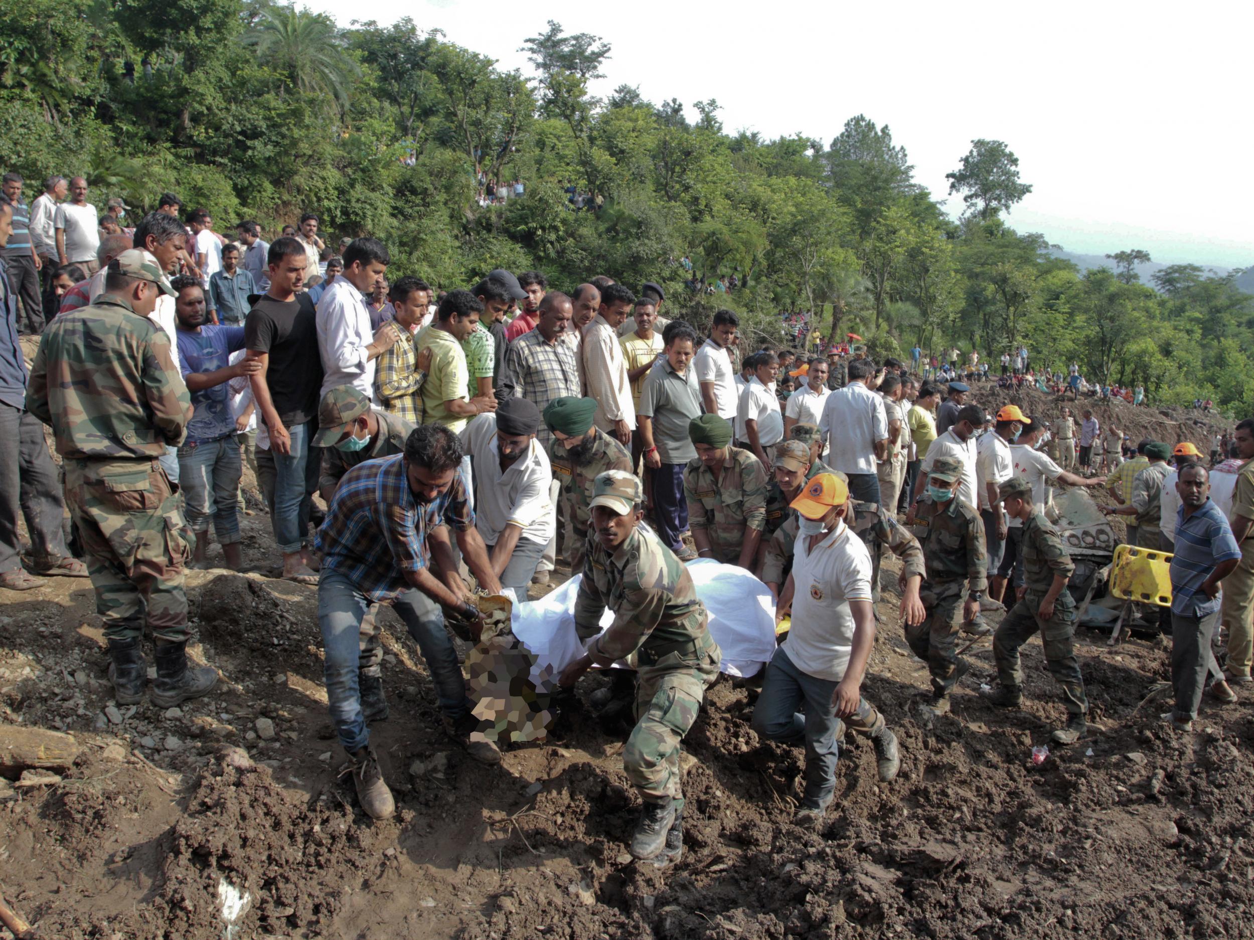 Soldiers used shovels and pickaxes to remove rocks, boulders and debris covering the buses and pull out the bodies