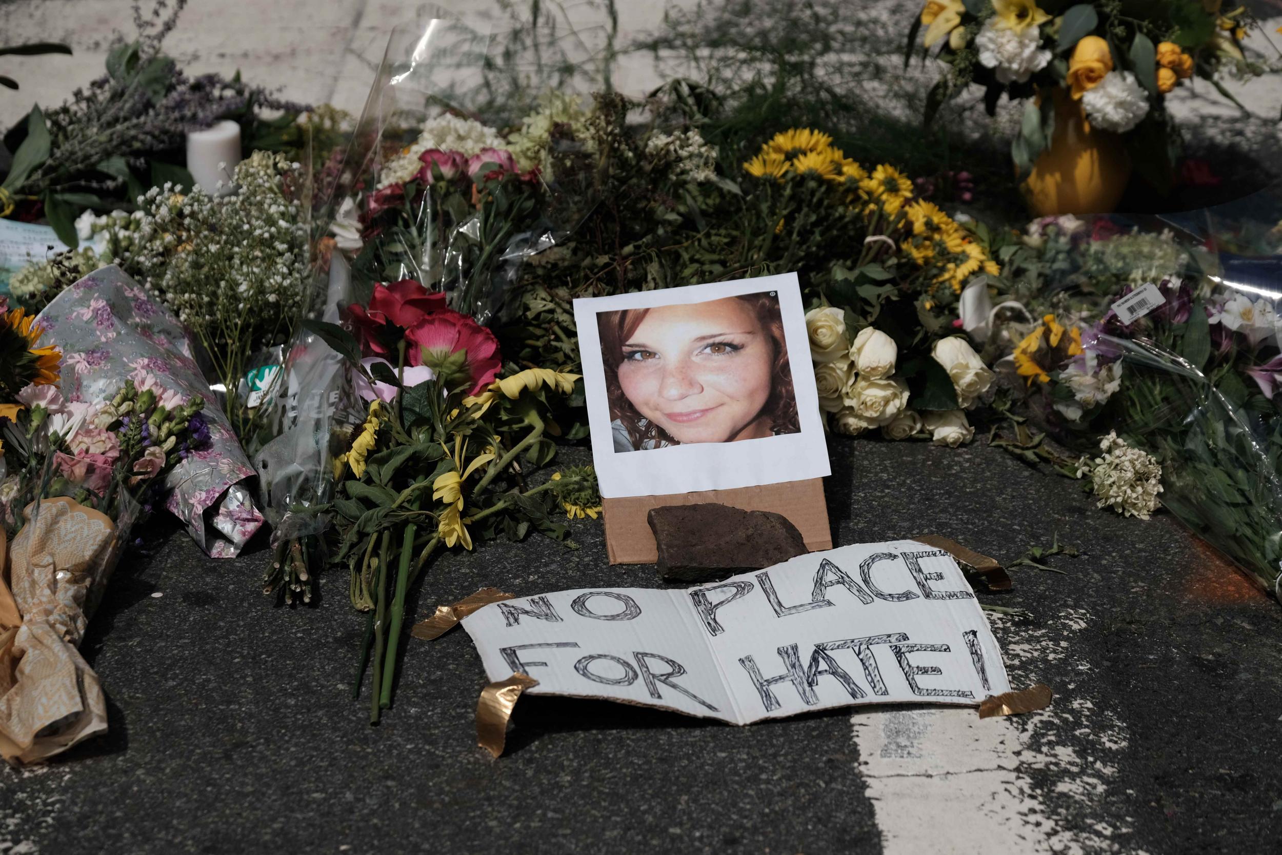 Flowers and a photo of Heather Heyer lie at a makeshift memorial in Charlottesville