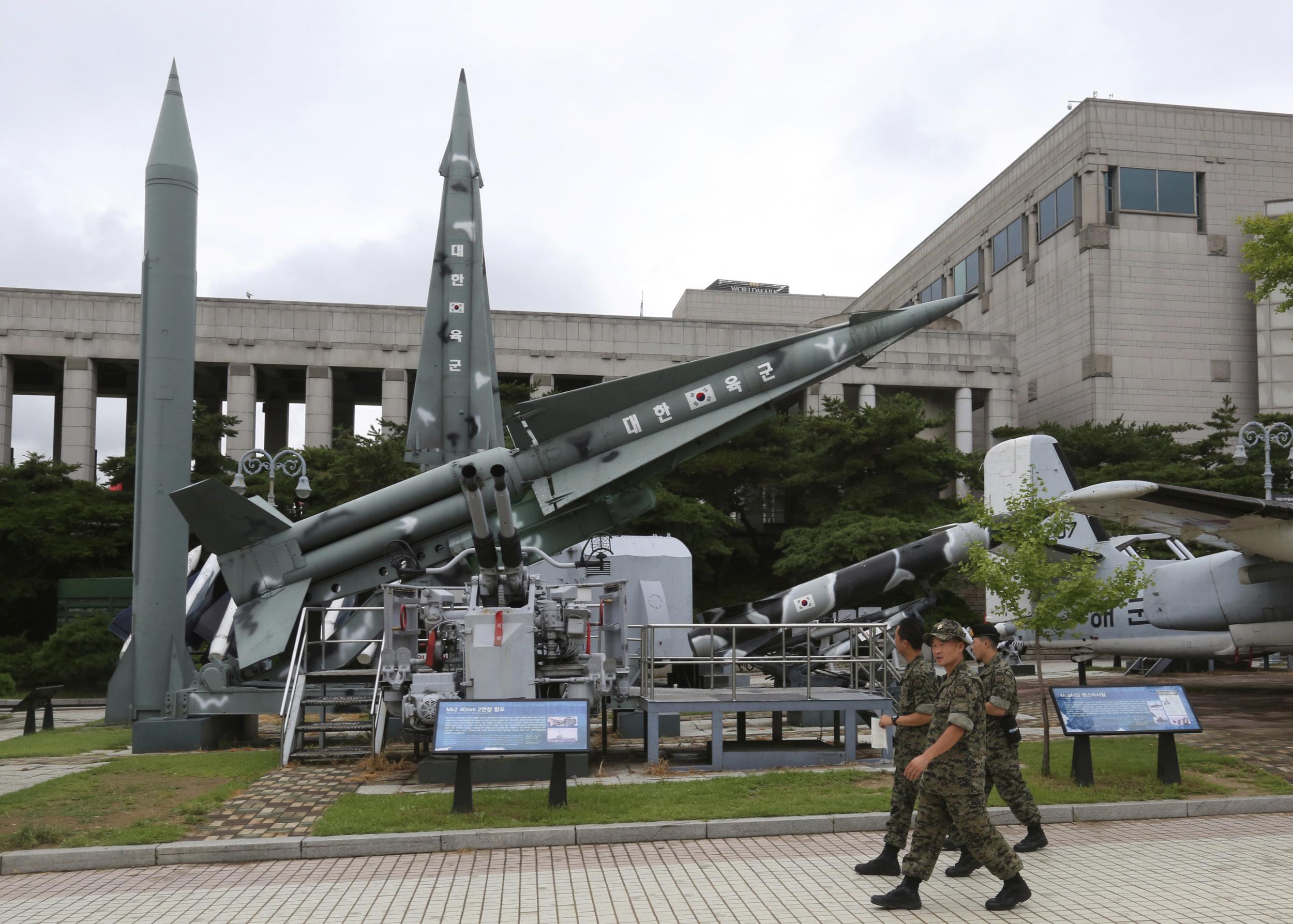 South Korean army soldiers walk by a mock Scud-B missile of North Korea