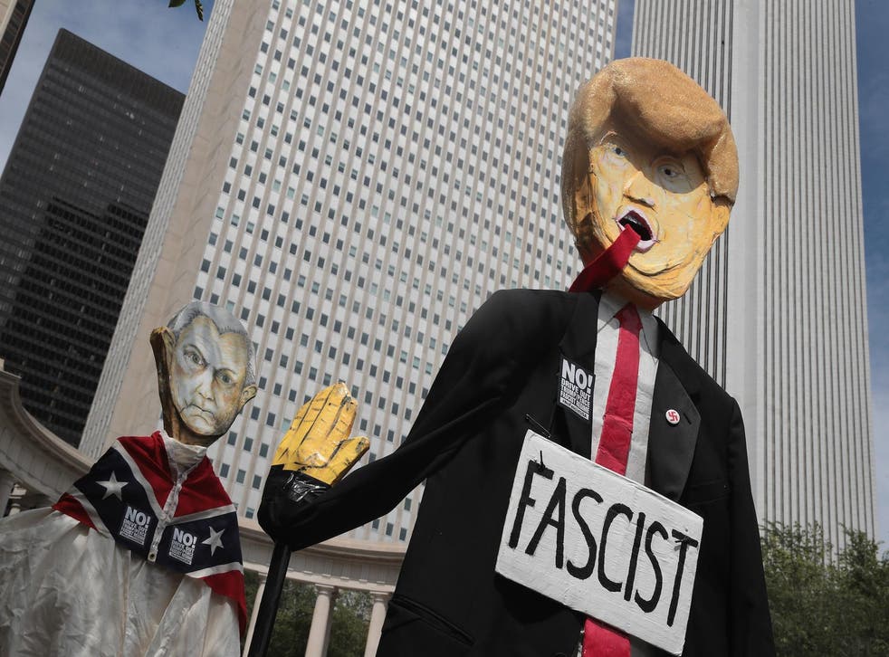 Demonstrators protesting the alt-right movement and mourning the victims of yesterdays rally in Charlottesville, Virginia carry puppets of President Donald Trump and  U.S. Attorney General Jeff Sessionson August 13, 2017 in Chicago, Illinois