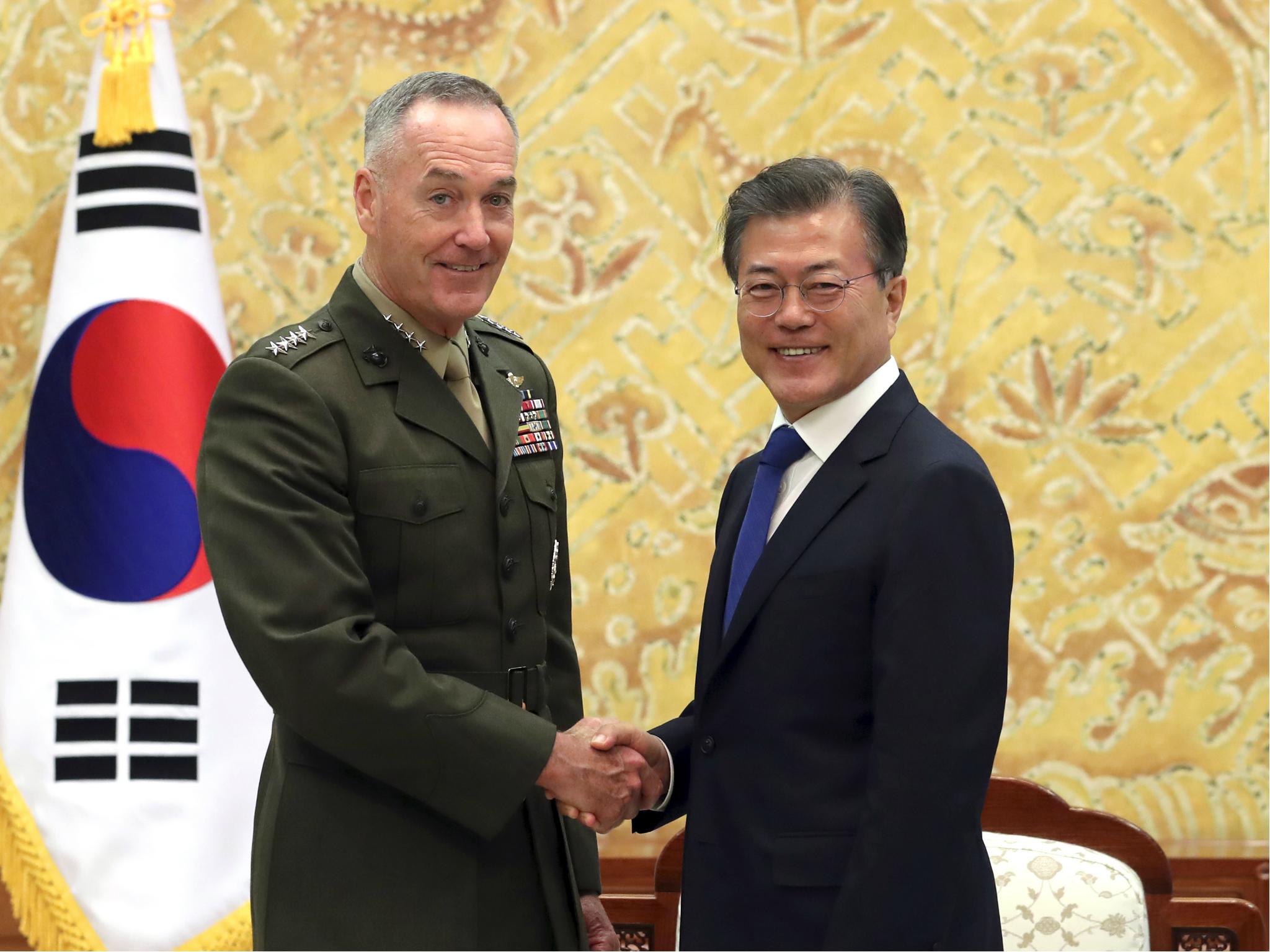 South Korean President Moon Jae-in poses with US Joint Chiefs Chairman General Joseph Dunford for a photo during a meeting at the presidential Blue House in Seoul, South Korea