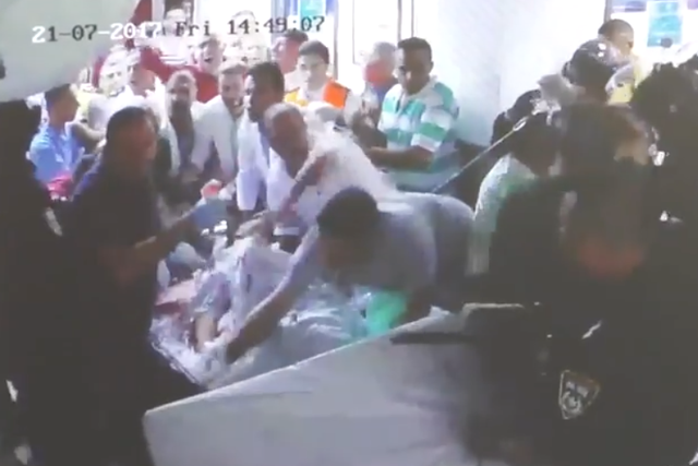 The security forces shoved staff aside to grab the stretcher injured 20-year-old Muhammed Abu Ghanam is lying on, preventing doctors from taking him to the operating theatre