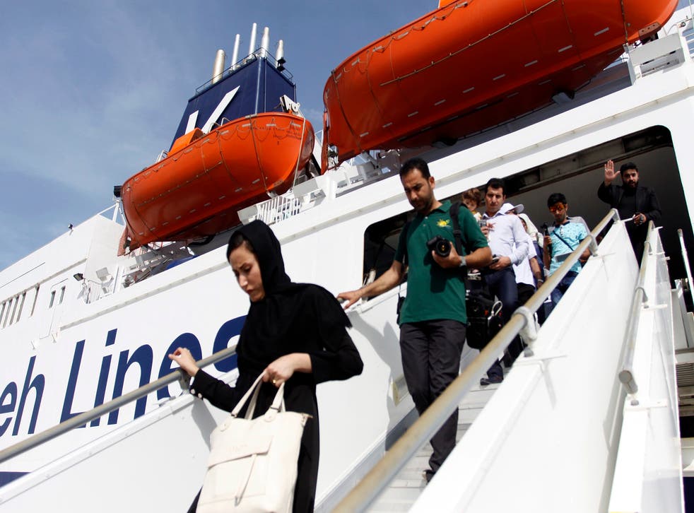 Passengers disembark after the maiden voyage of Iran's first cruise ship built since the 1979 Islamic Revolution, on the Gulf resort island of Qeshm in April this year