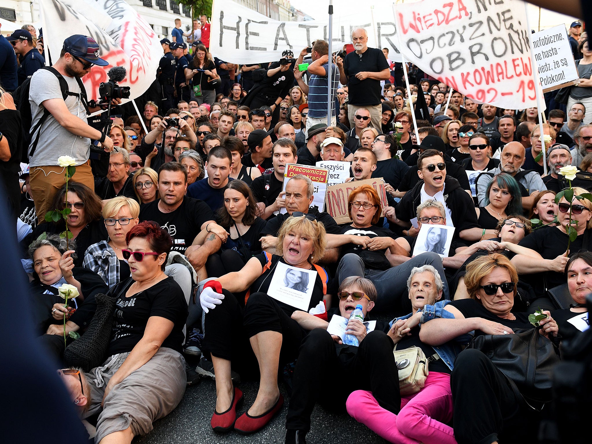 Women activists try to block a far-right extremists marching to celebrate the Polish Army Day