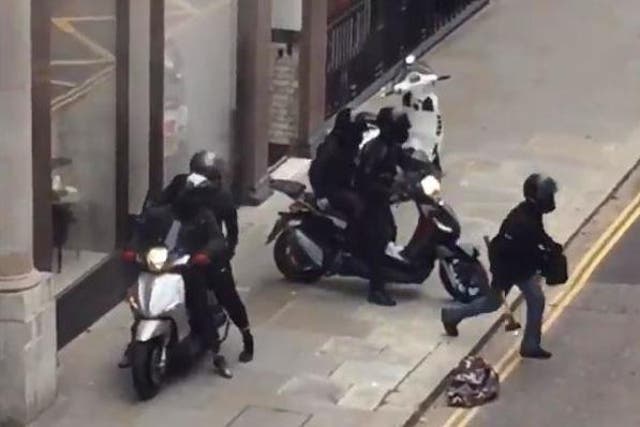 The robbers were seen leaving the shop wielding hammers before speeding off on mopeds