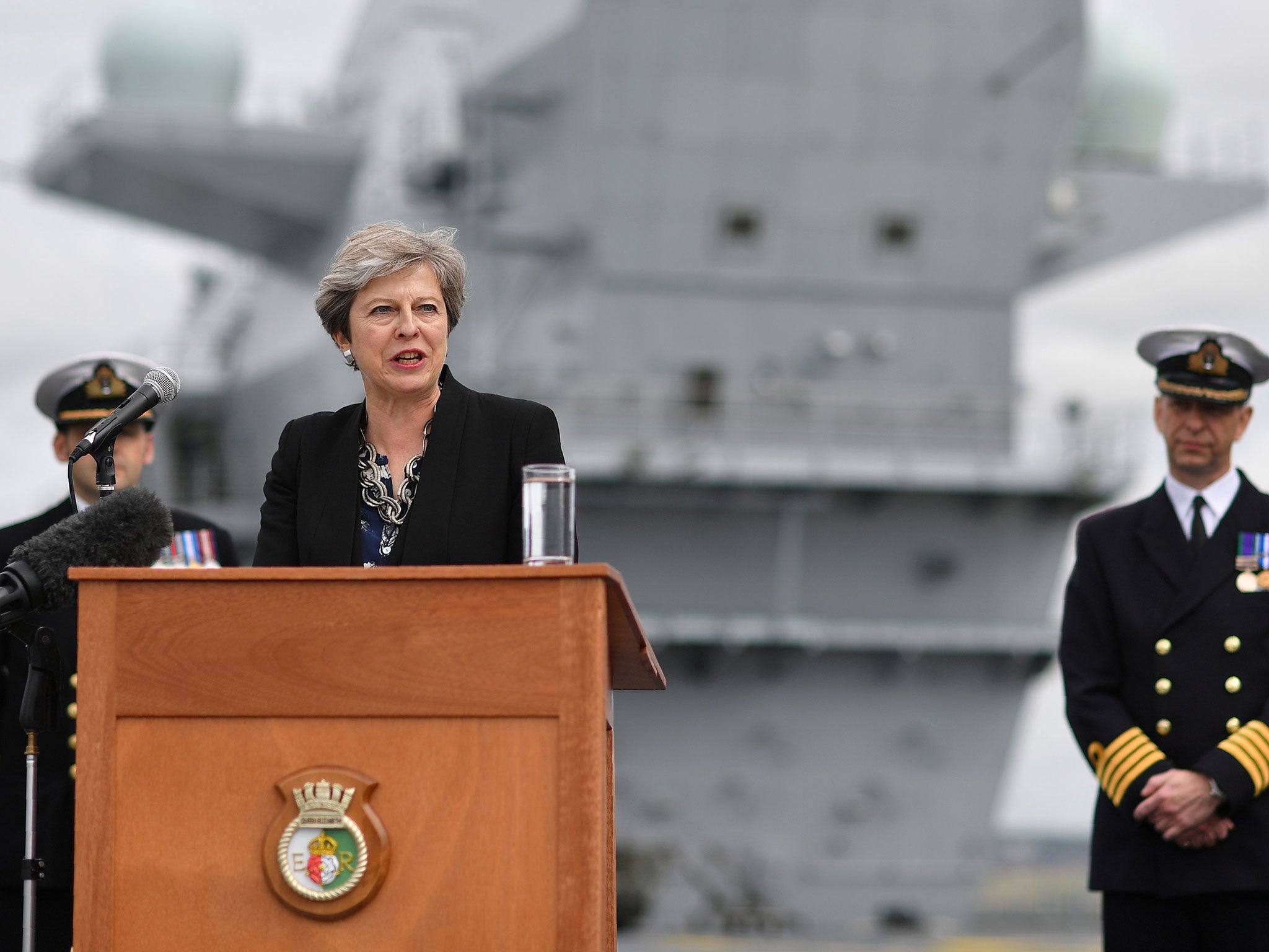 Theresa May stands on the flight deck as she speaks to crew members of the British aircraft carrier HMS Queen Elizabeth in Portsmouth on 16 August