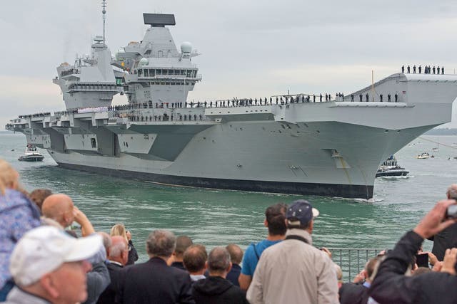 Crowds watch as HMS Queen Elizabeth, the UK's newest aircraft carrier, arrives in Portsmouth.