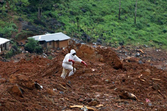 A rescue worker is seen at the scene of the mudslide in the mountain town of Regent, Sierra Leone