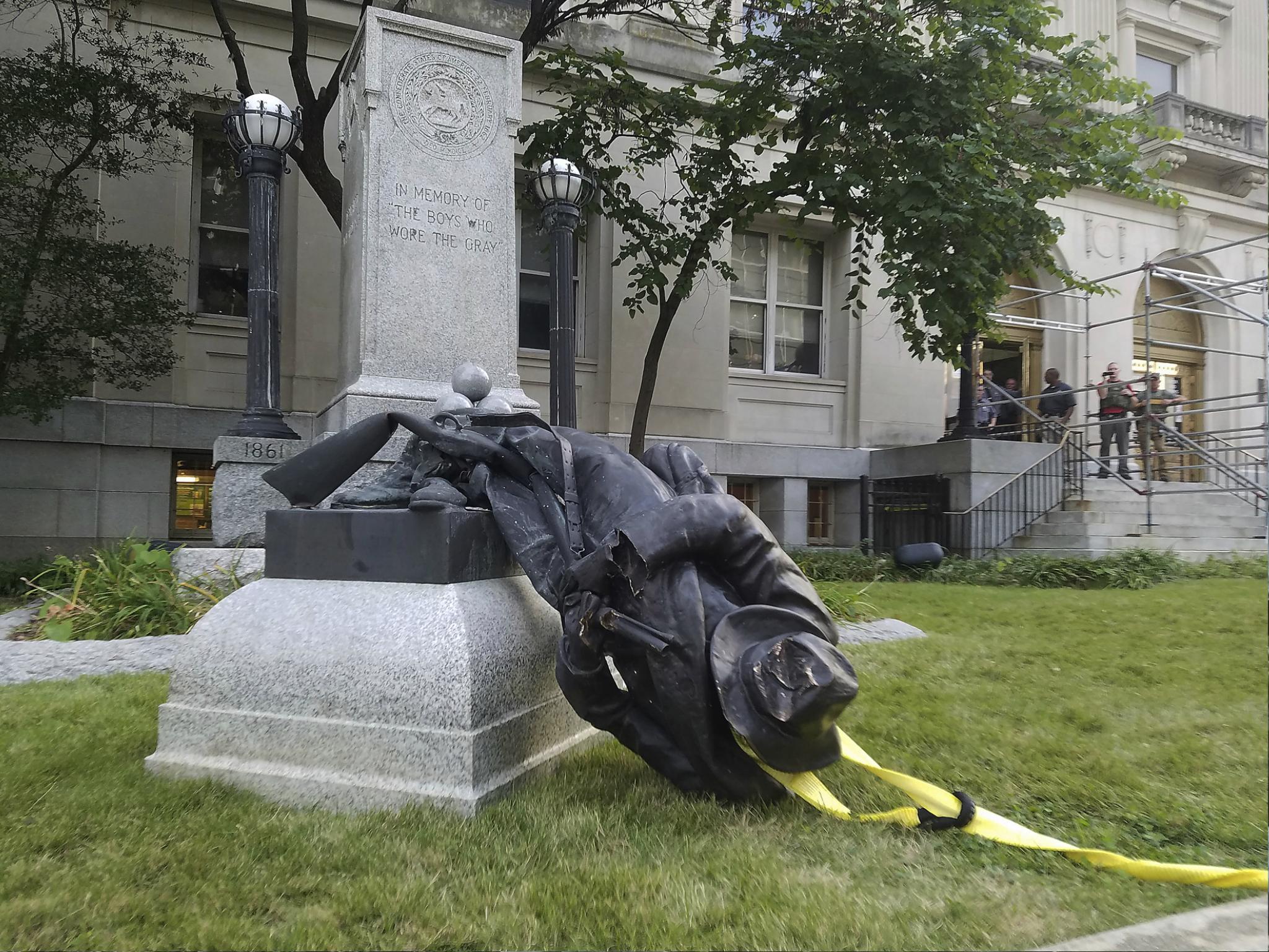 A toppled Confederate statue lies on the ground on 14 August 2017 in Durham, North Carolina where activists used a rope to pull it down after the violence in Charlottesville, Virginia