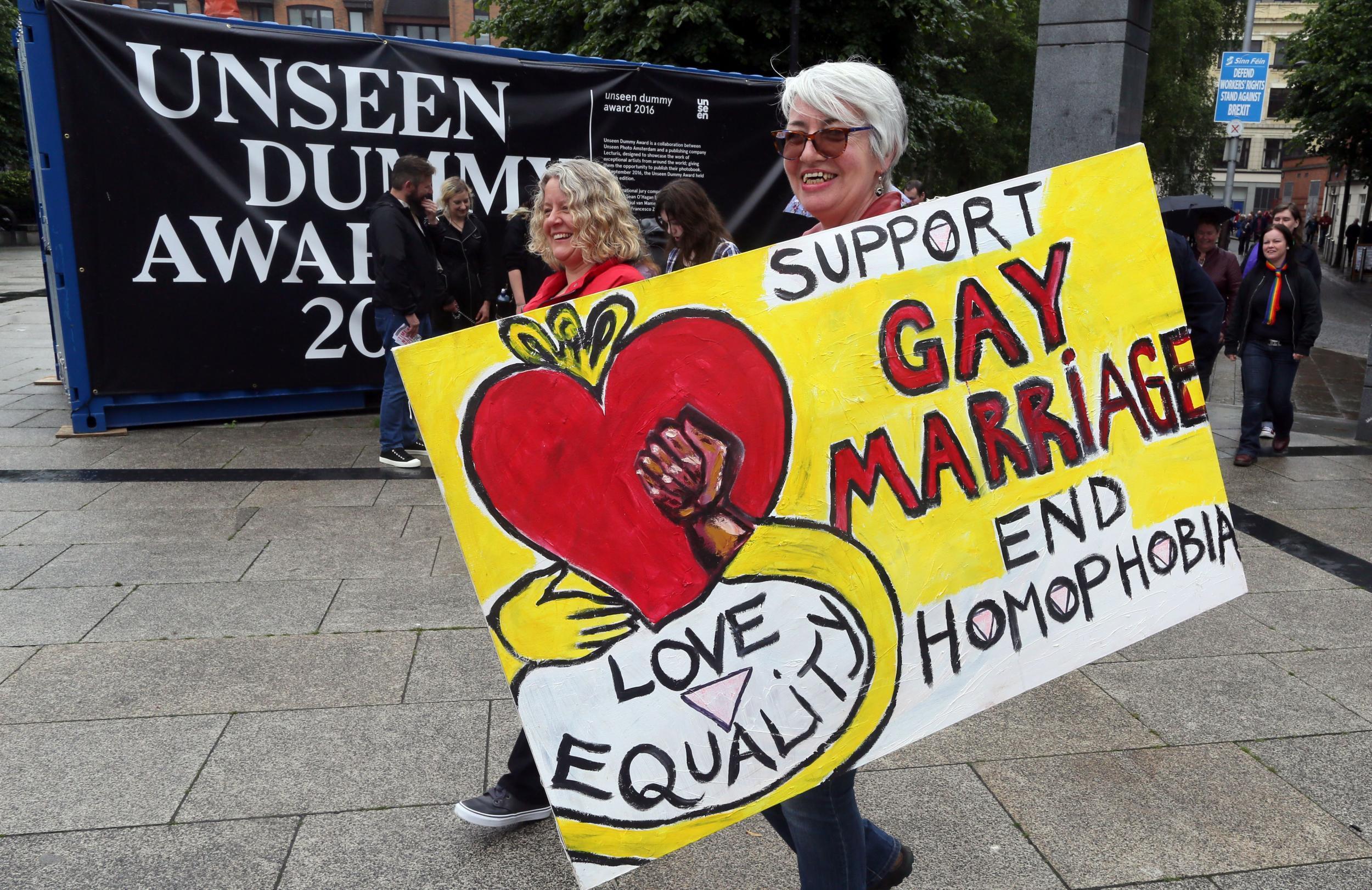 Gay rights campaigners take part in a march through Belfast on July 1, 2017 to protest against the ban on same-sex marriage