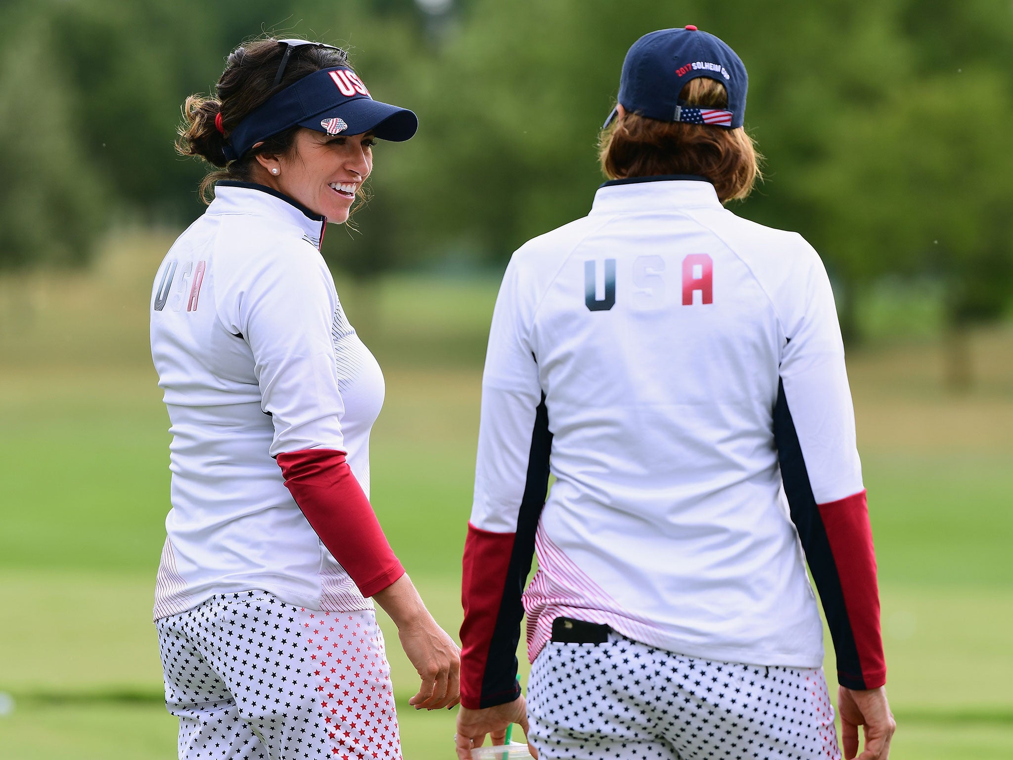 Gerina Piller of the United States smiles with captain Juli Inkster during practice for the Solheim Cup