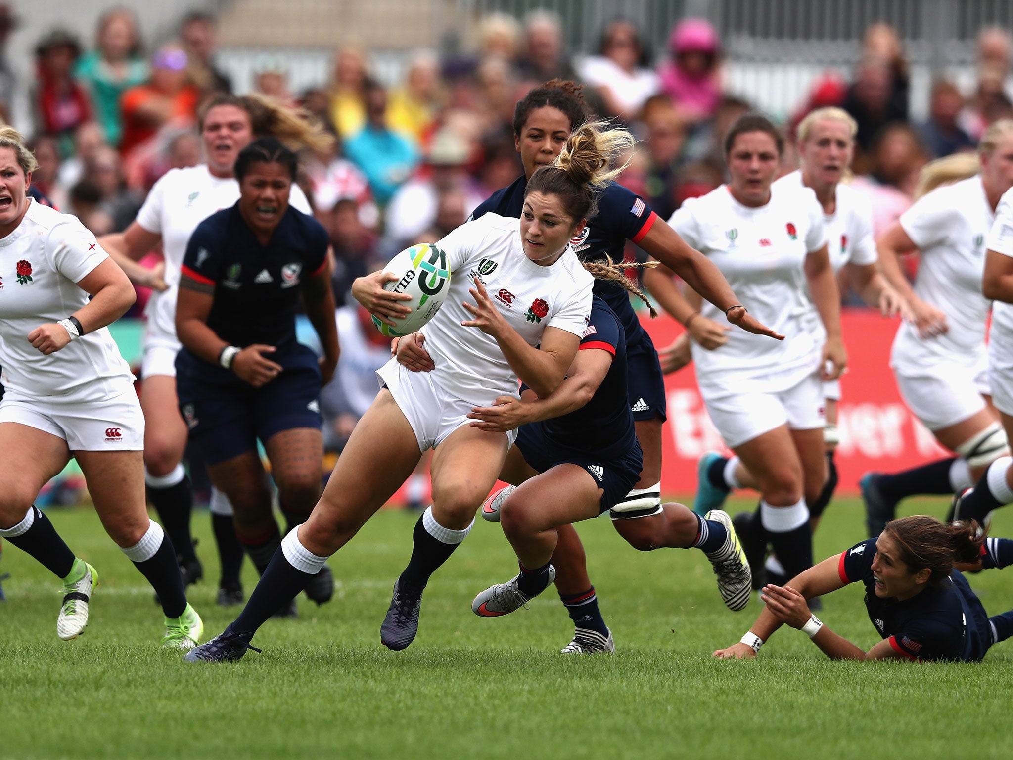 Amy Wilson Hardy of England is brought to ground by the US defence