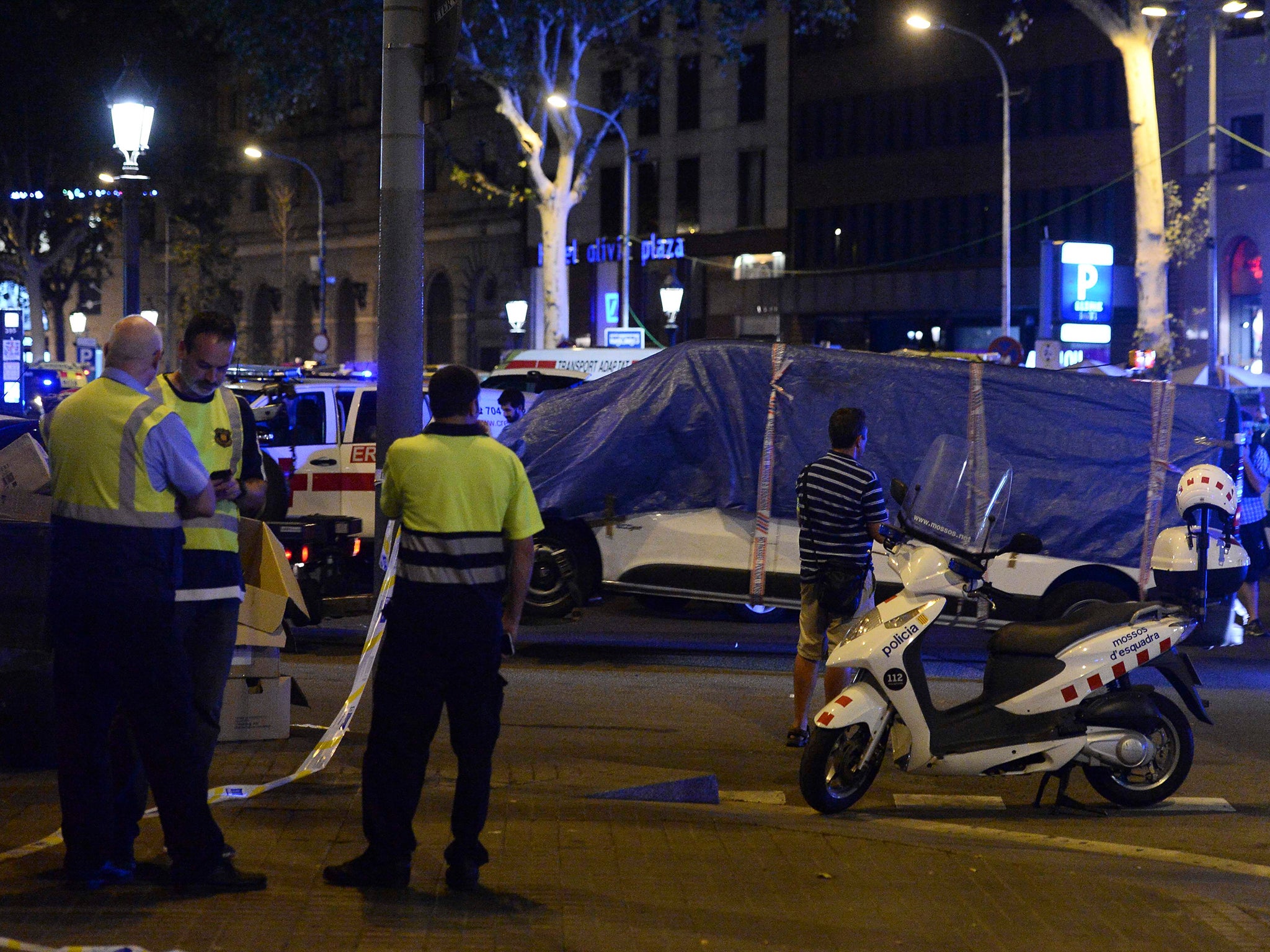 The van that ploughed into the crowd, killing 13 people and injuring around 100 others, is towed away from La Rambla in Barcelona