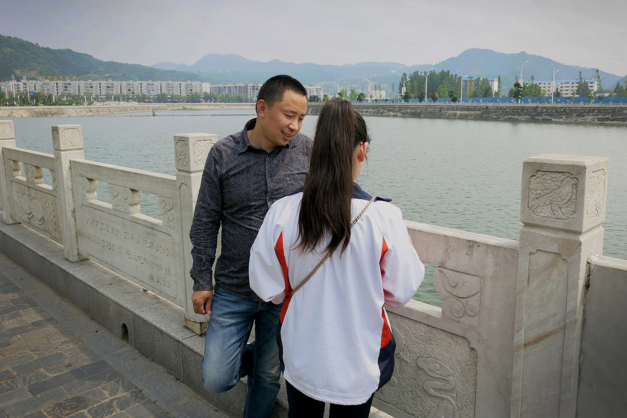 Cheng Zhu, 43, talks to his daughter Cheng Ying, 16, who is reunited with him after being abducted in 2005