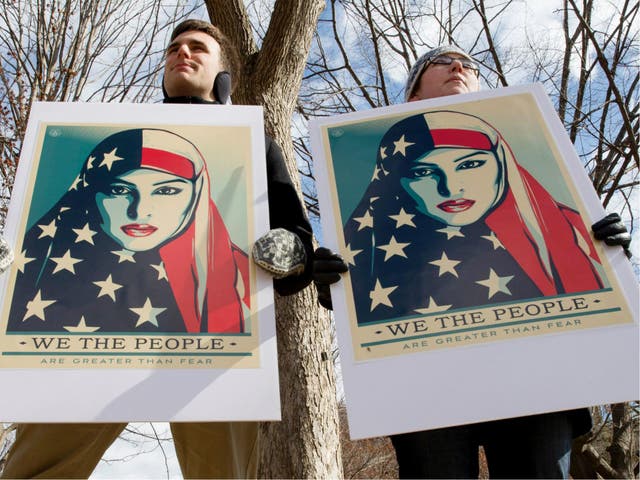Demonstrators gather near The White House to protest President Donald Trump's travel ban on six Muslim countries on 11 March 2017. Mr Trump took to Twitter to attack the courts and Democrats for trying to block it