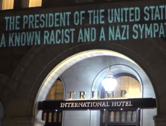 Robin Bell projected the message onto the hotel amid criticism of Donald Trump's response to the Virginia violence