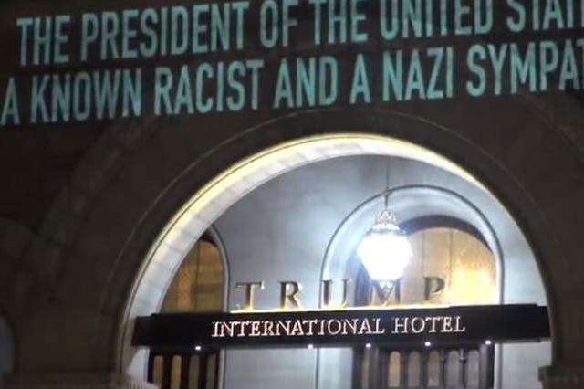 Robin Bell projected the message onto the hotel amid criticism of Donald Trump's response to the Virginia violence