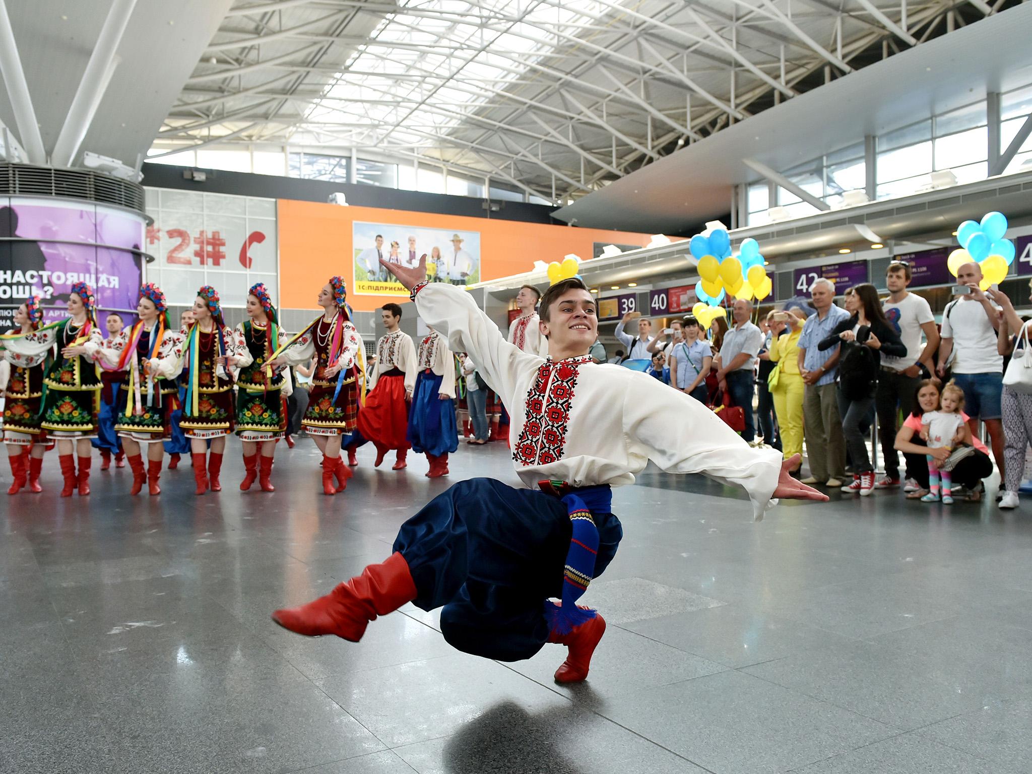 Traditional dancers perform in Kiev on the first day of visa-free travel for Ukrainian nationals to the EU
