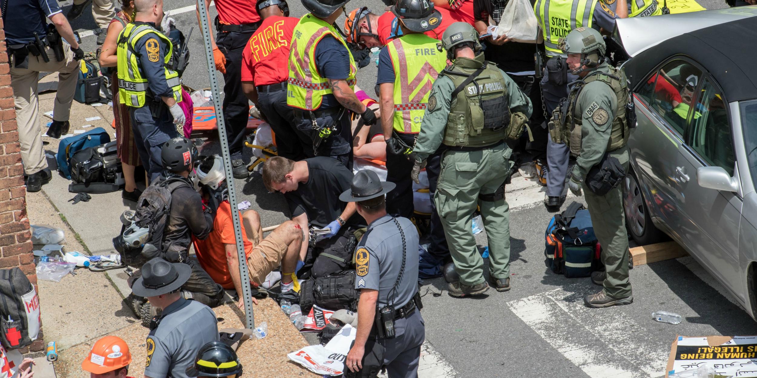 People receive first-aid after a car ran into a crowd of protesters in Charlottesville