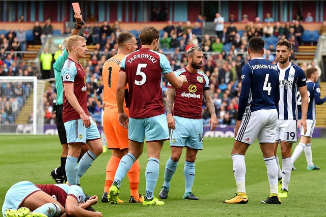 Hal Robson-Kanu is shown a straight red card for an elbow to Matt Lowton