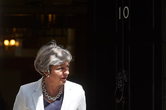 Theresa May exits 10 Downing Street in central London on July 18, 2017