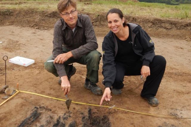 Researchers Søren M. Sindbæk and Nanna Holm show the remains of the charred planks at one of the gateways to the fortress