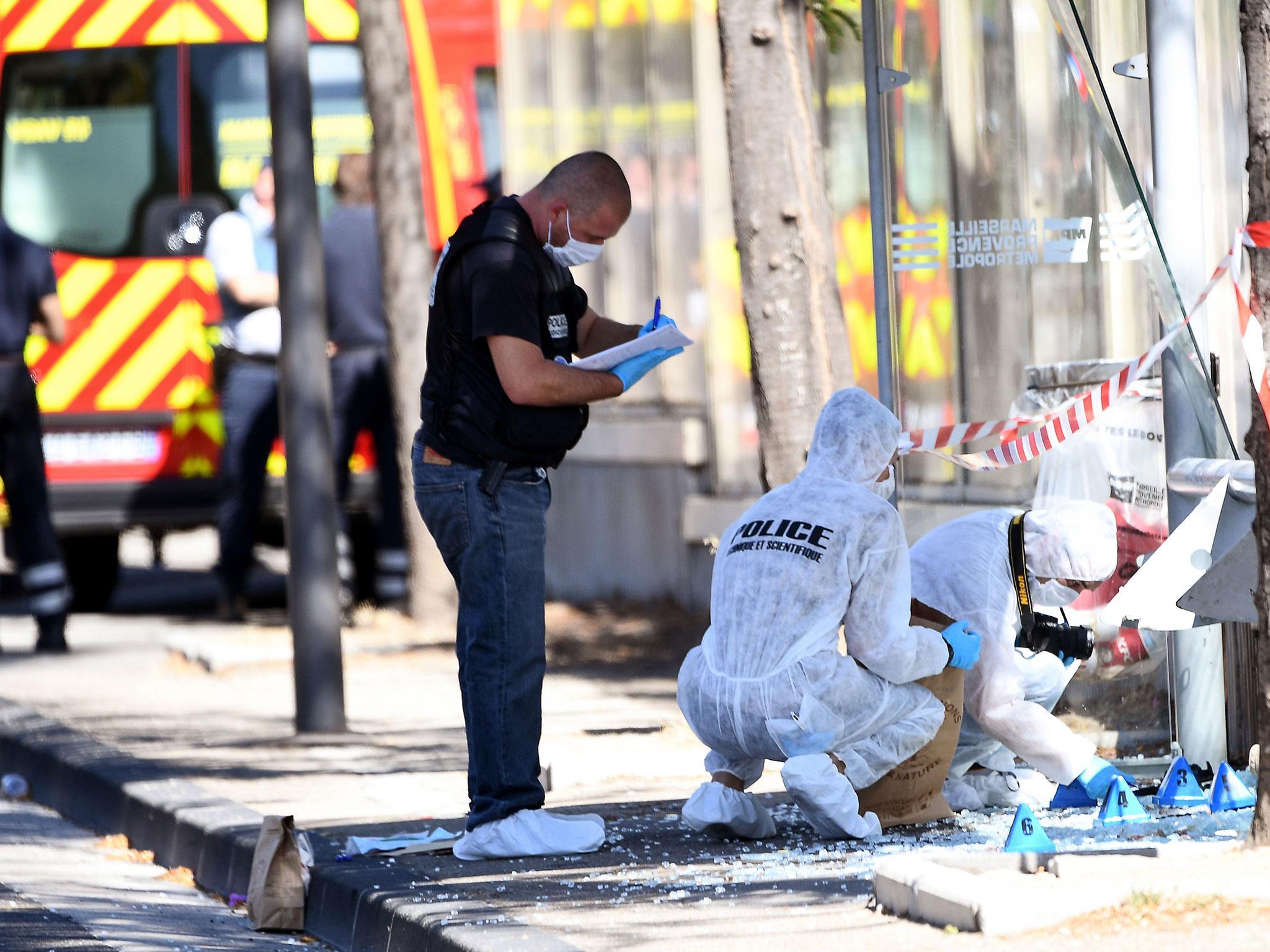 French forensic police search the site following the crash