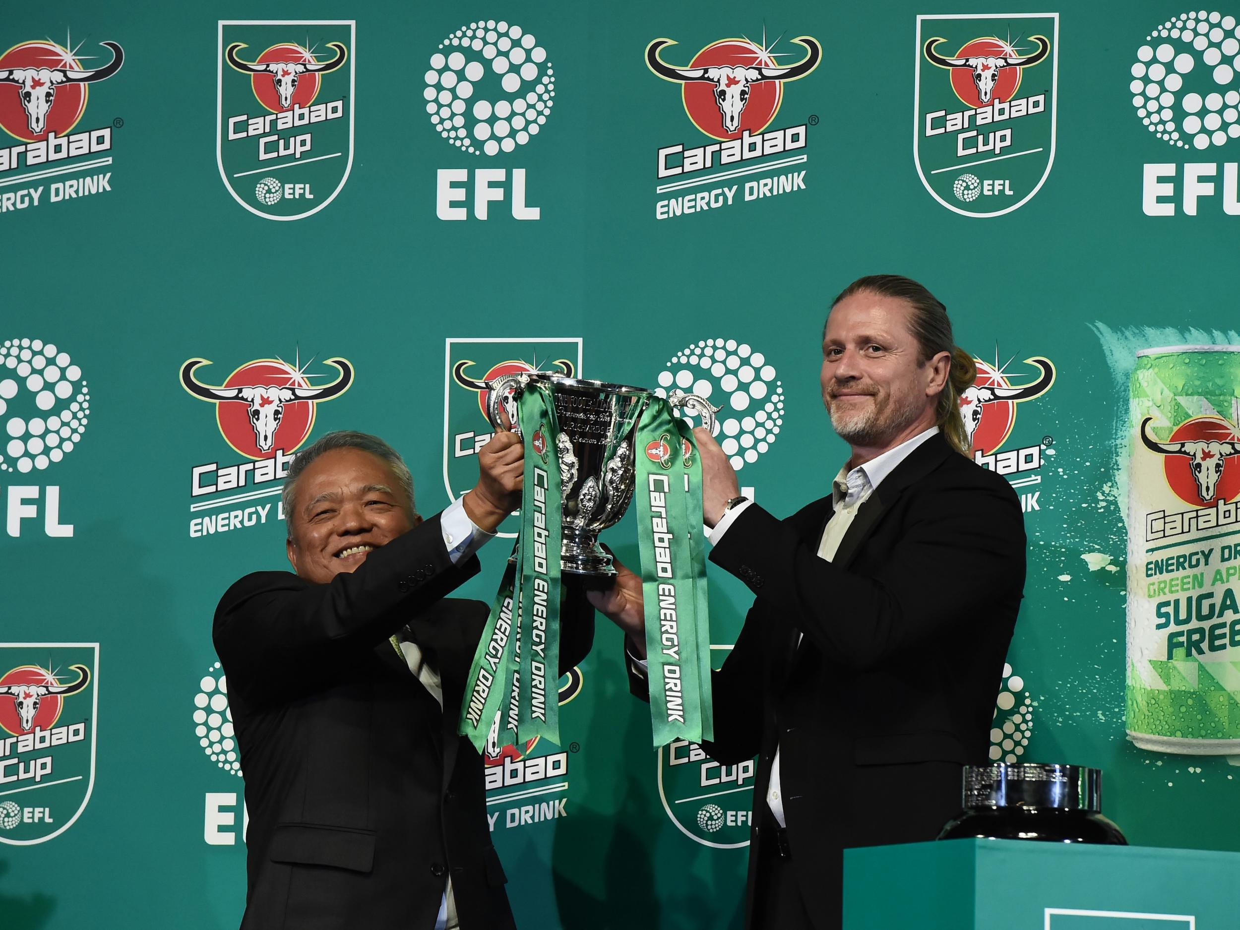 Carabao CEO Sathien Setthasit with former Arsenal and Chelsea midfielder Emmanuel Petit at the the first round draw in Bangkok
