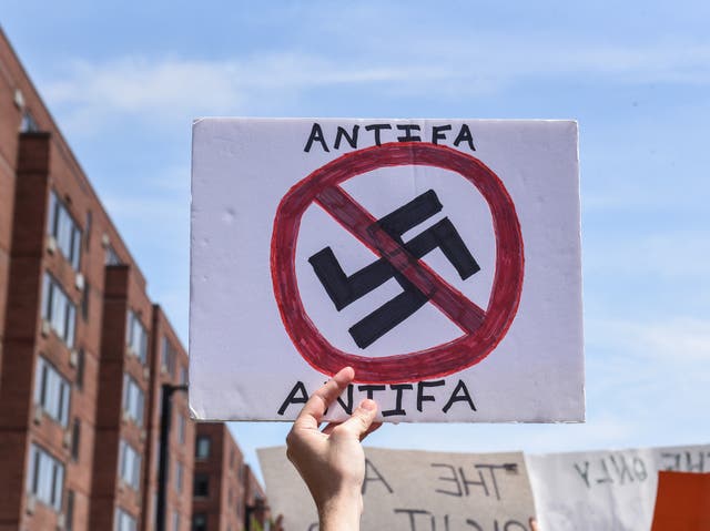 A counter protester holds a sign with the words "Antifa" (anti-fascists) outside of the Boston Commons and the Boston Free Speech Rally in Boston