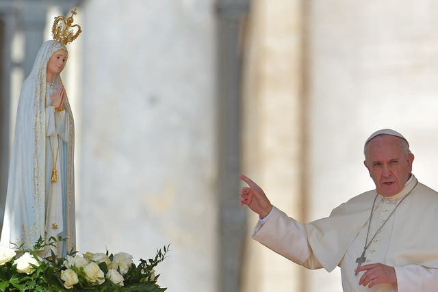Pope Francis with a figure of Our Lady of Fatima who the group claim predicted the rise of an antipope